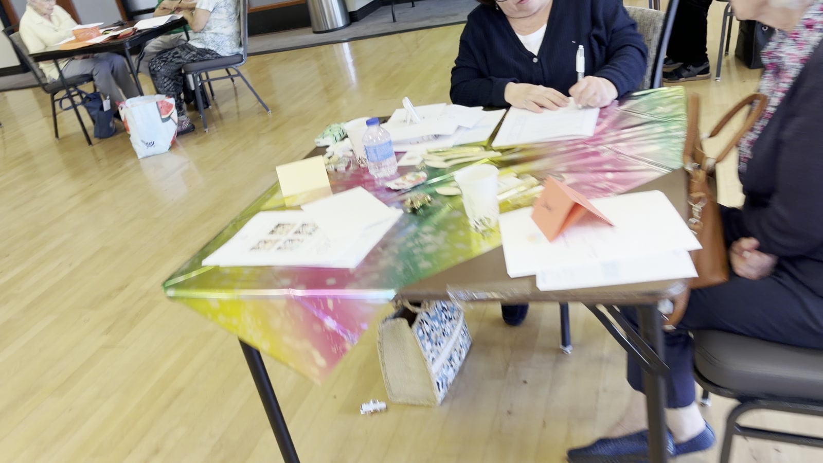 A participant writing at the workshop table