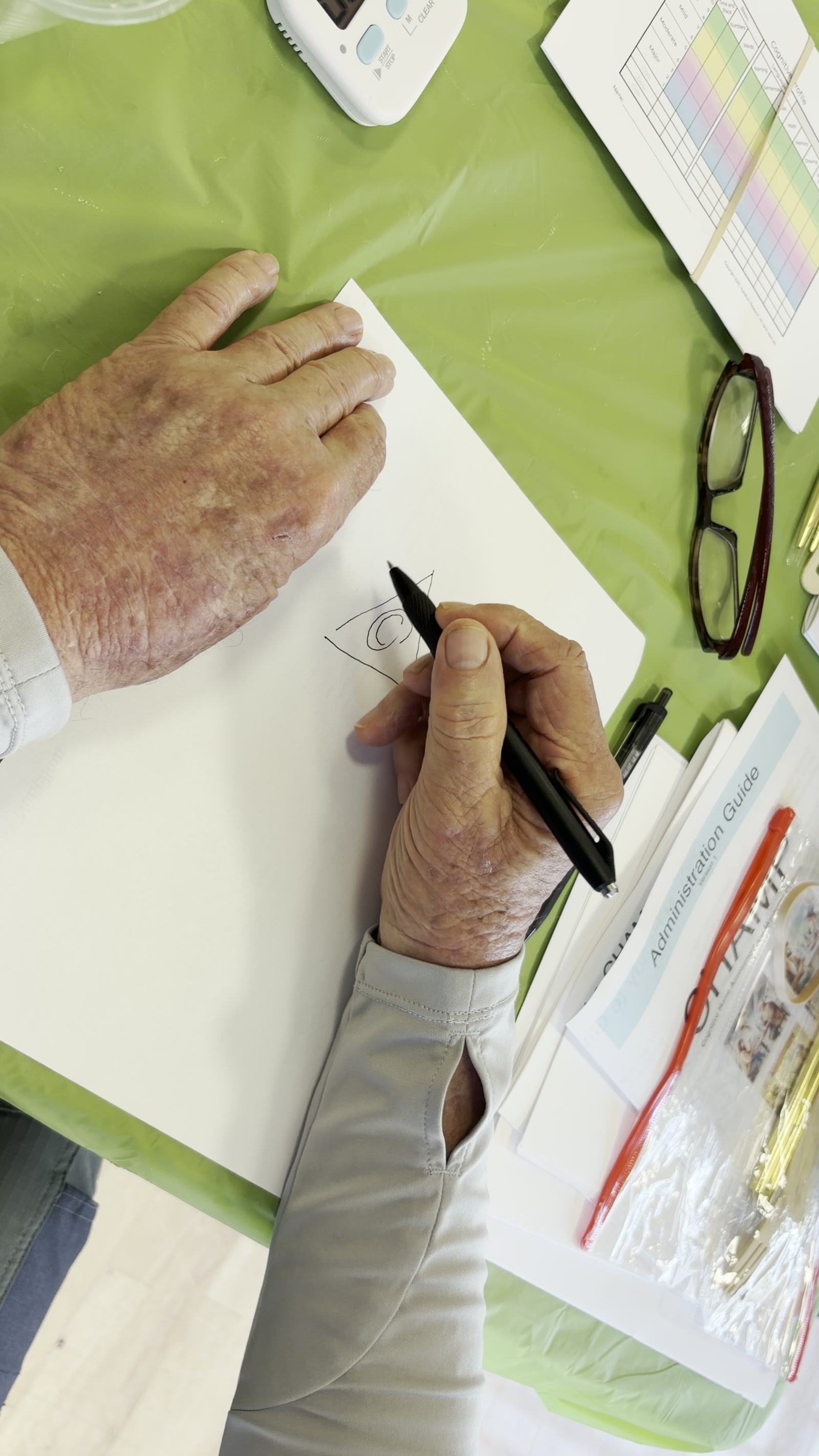 A senior drawing the figure on the worksheet